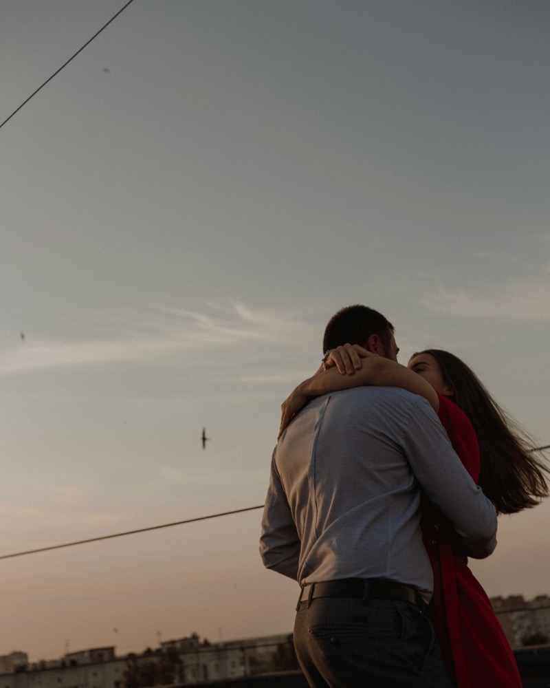Couple embracing at sunset