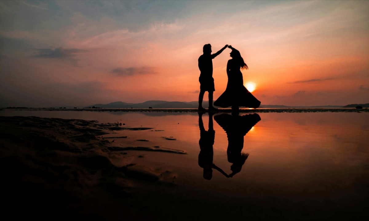 Couple dancing together at sunset